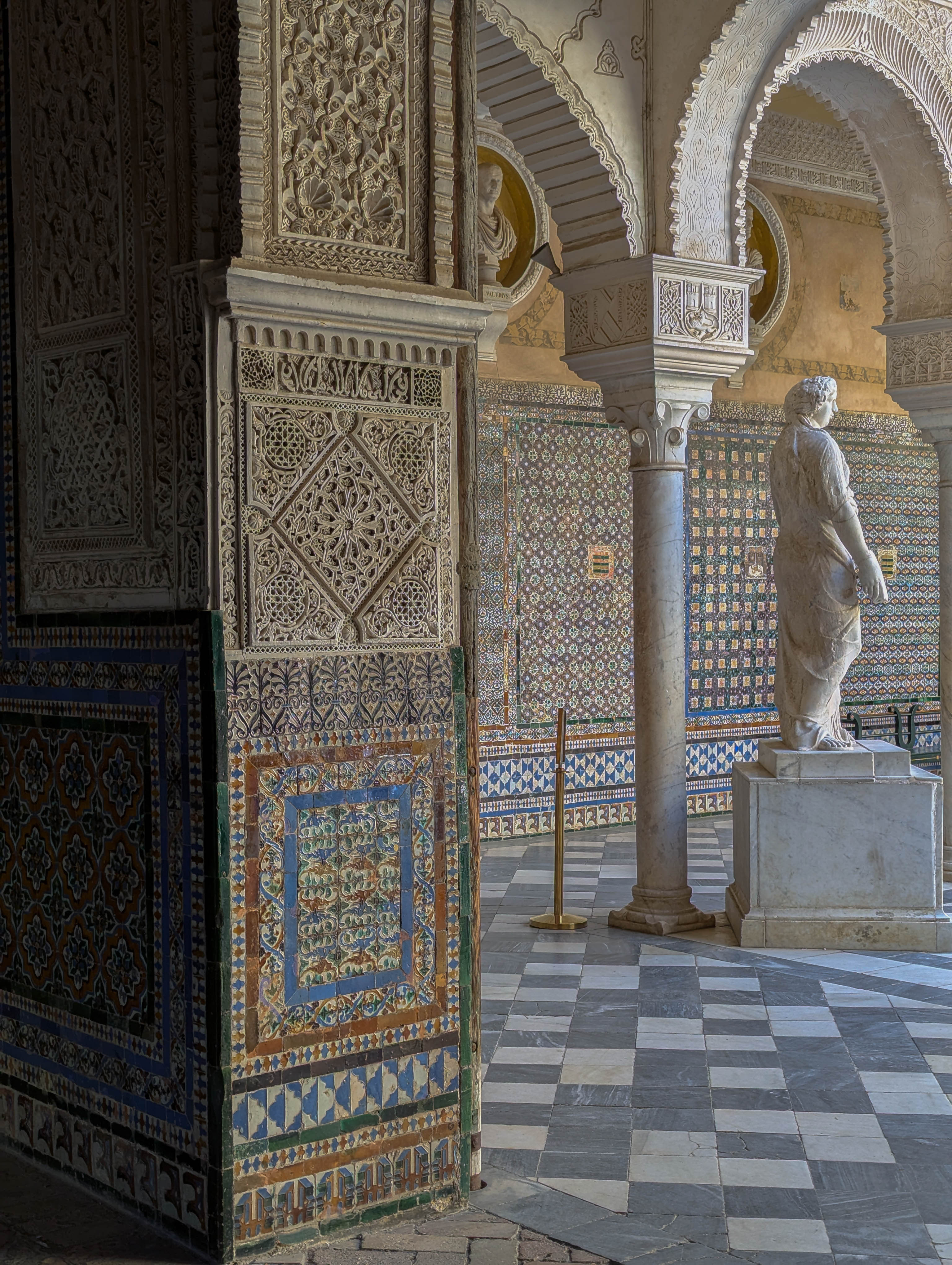 Beautiful tiles of a courtyard with a statue
